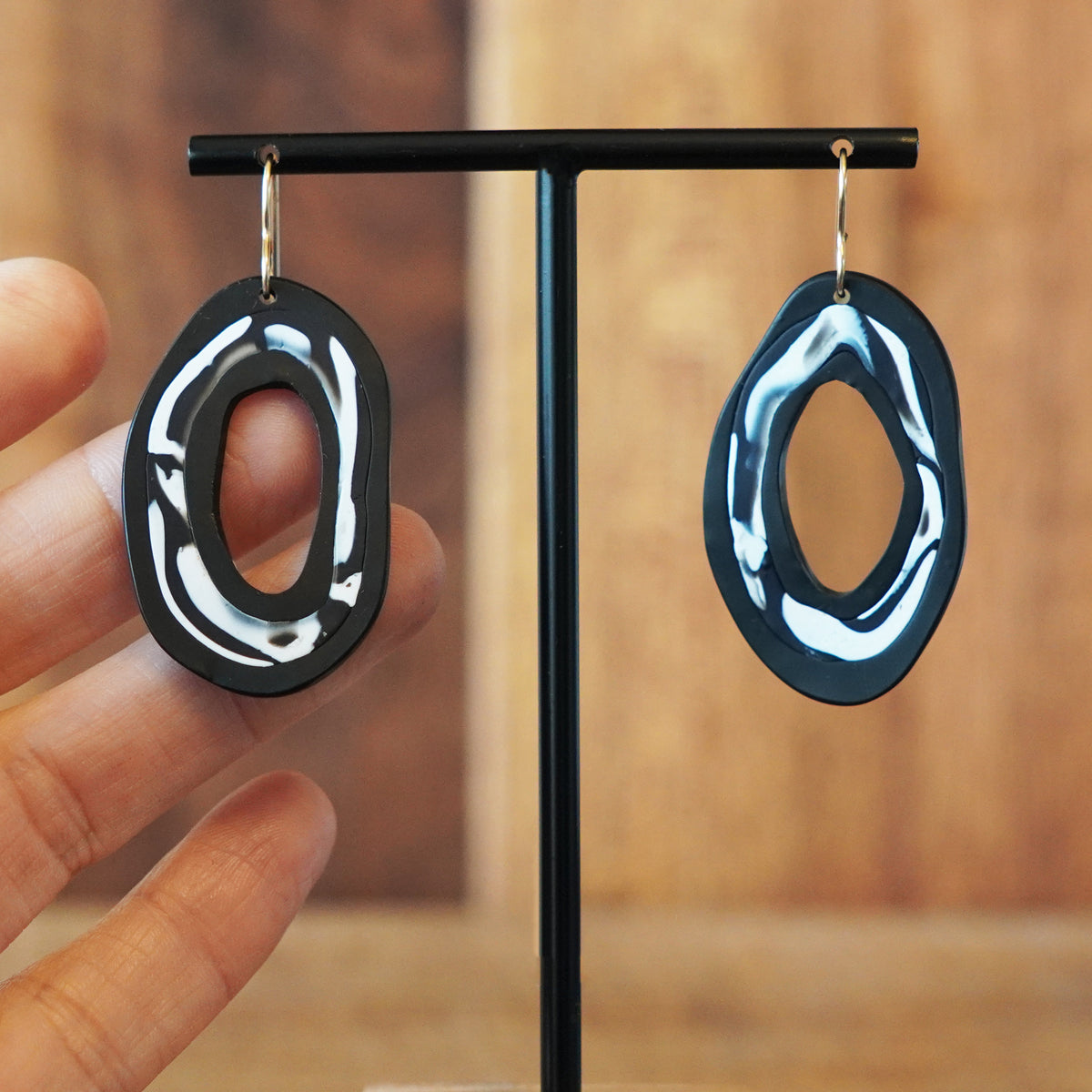 Unique and one of a kind black and white polymer clay hoop statement earrings handmade by Jax Atelier in San Diego