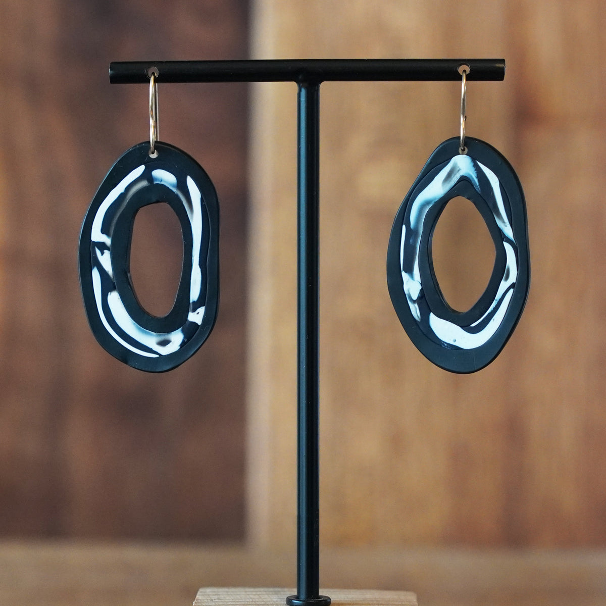 Artistic black and white polymer clay hoop statement earrings handmade by Jax Atelier in San Diego